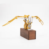 Finished DIY mechanical metal model with flapping wings displayed on desk