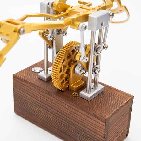 Finished DIY mechanical metal model with flapping wings displayed on desk