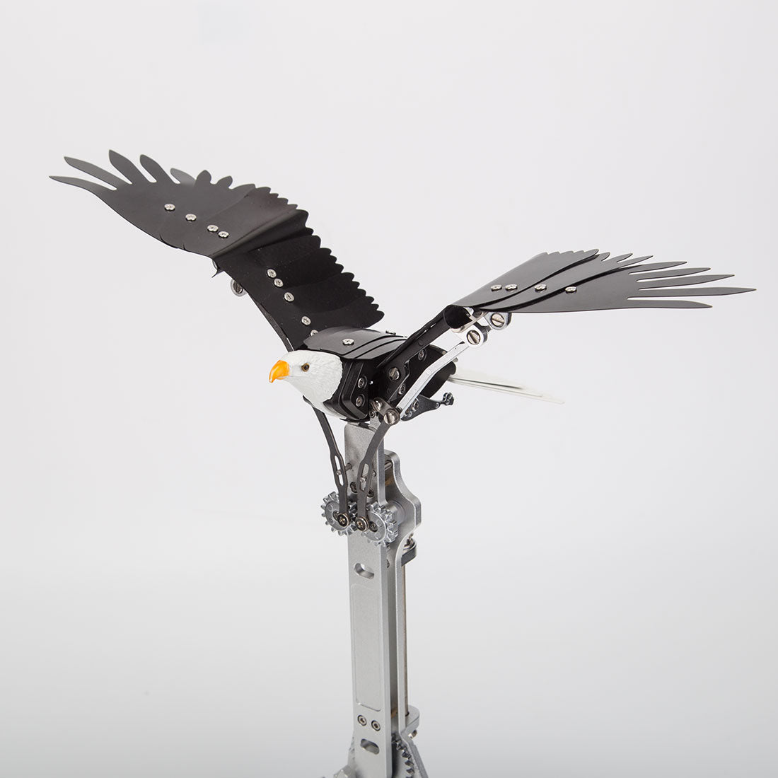 Close-up of aluminum alloy mechanical bird model showing CNC-machined parts, anodized finish and articulated wing structure - VICTMAX